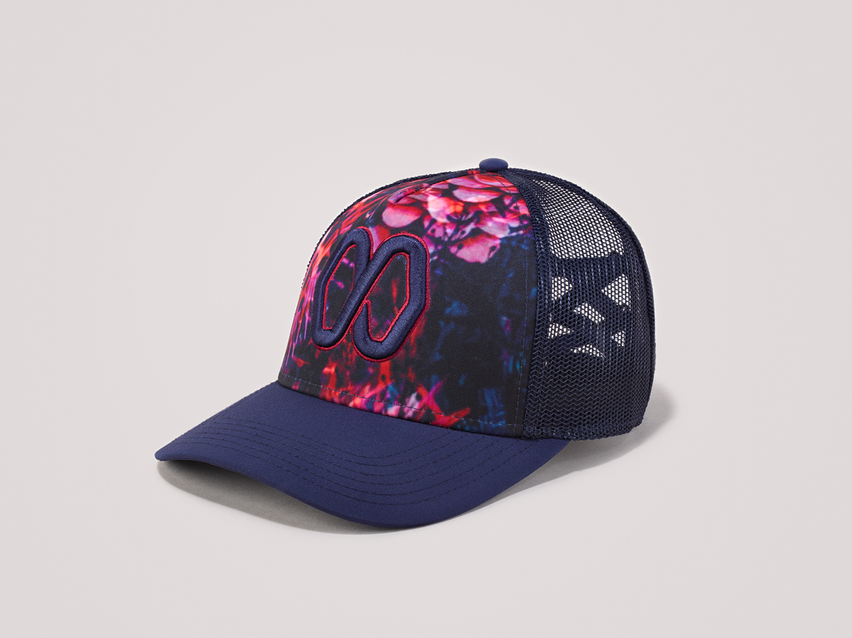 Ponytail baseball hat with blue and pink print. Mesh trucker style. Rear opening with cross tie.